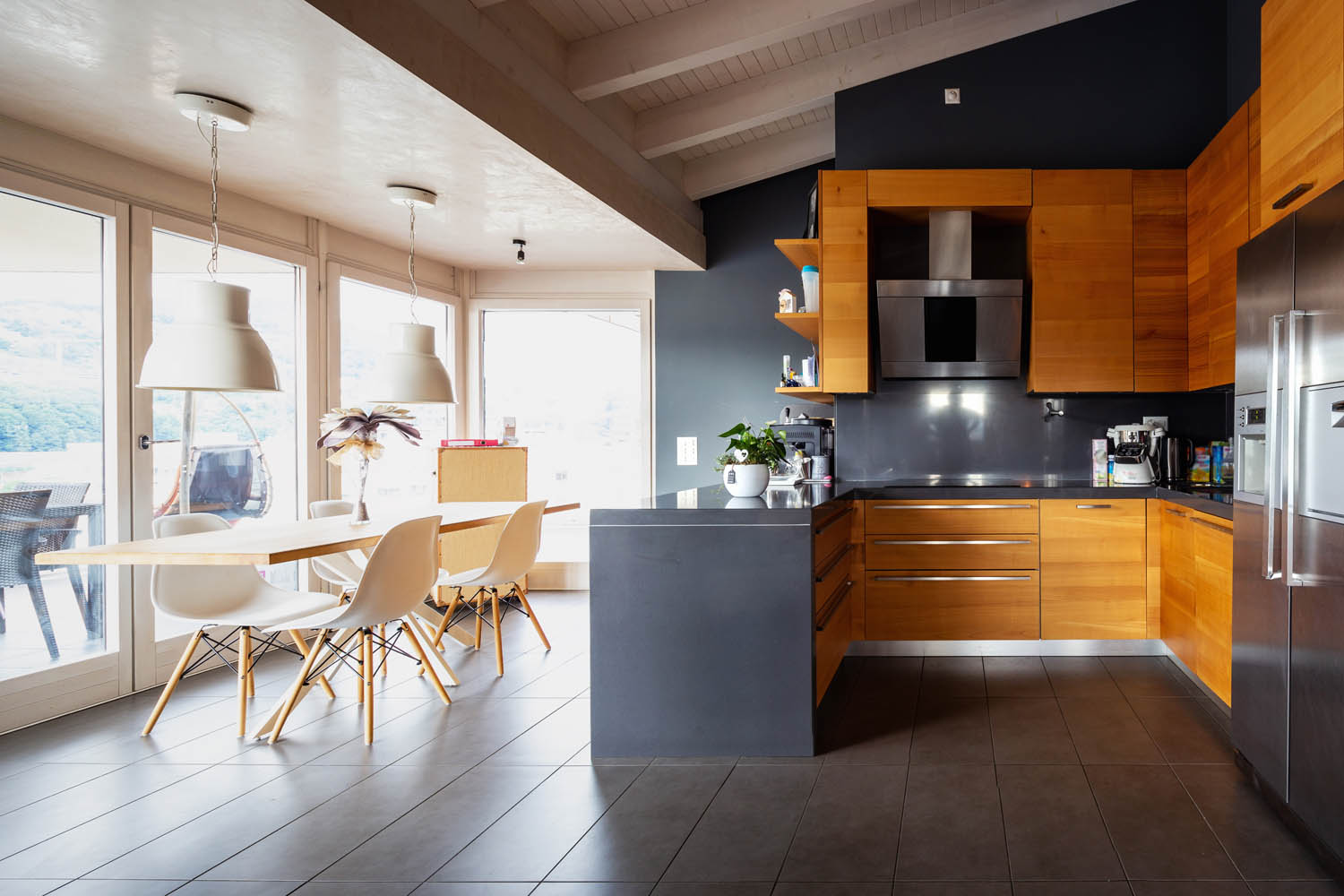 A residential kitchen witht black decorations beautifully lit up after a whole home electrical upgrade in Santa Barbara, CA.